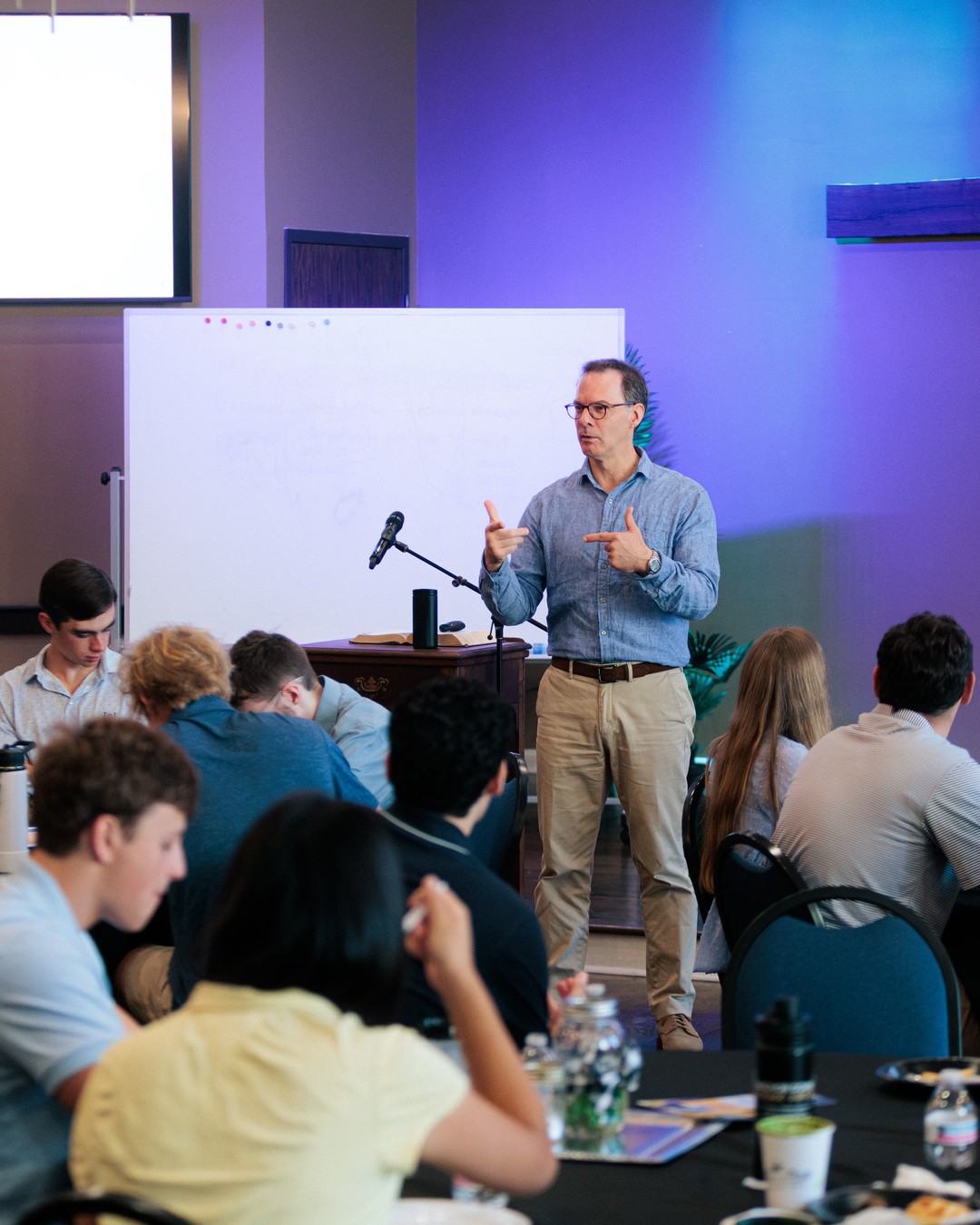 Young people gathered around tables for Bible teaching at Nashville First